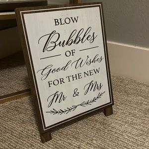 Blow bubbles for the new Mr and Mrs wedding sign
